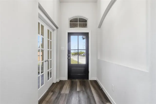 a view of an entryway door with wooden floor