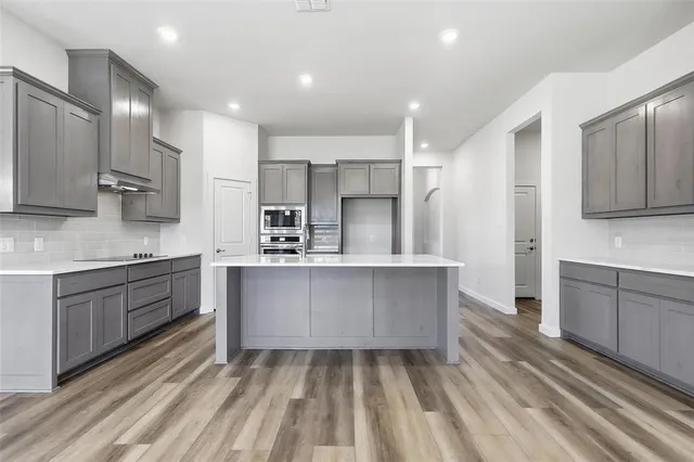 a kitchen with kitchen island cabinets and refrigerator