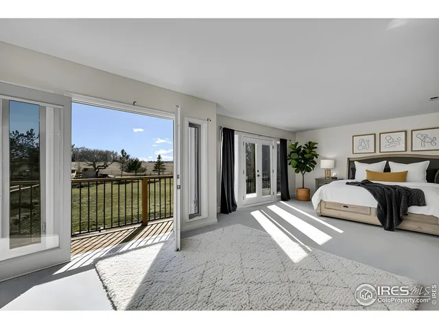 a bedroom with furniture and large windows