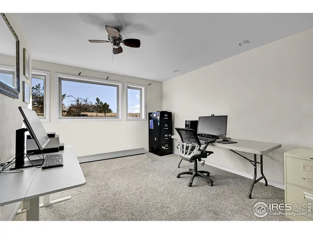 a work room with furniture and a ceiling fan