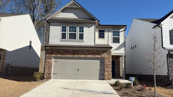 a front view of a house with parking