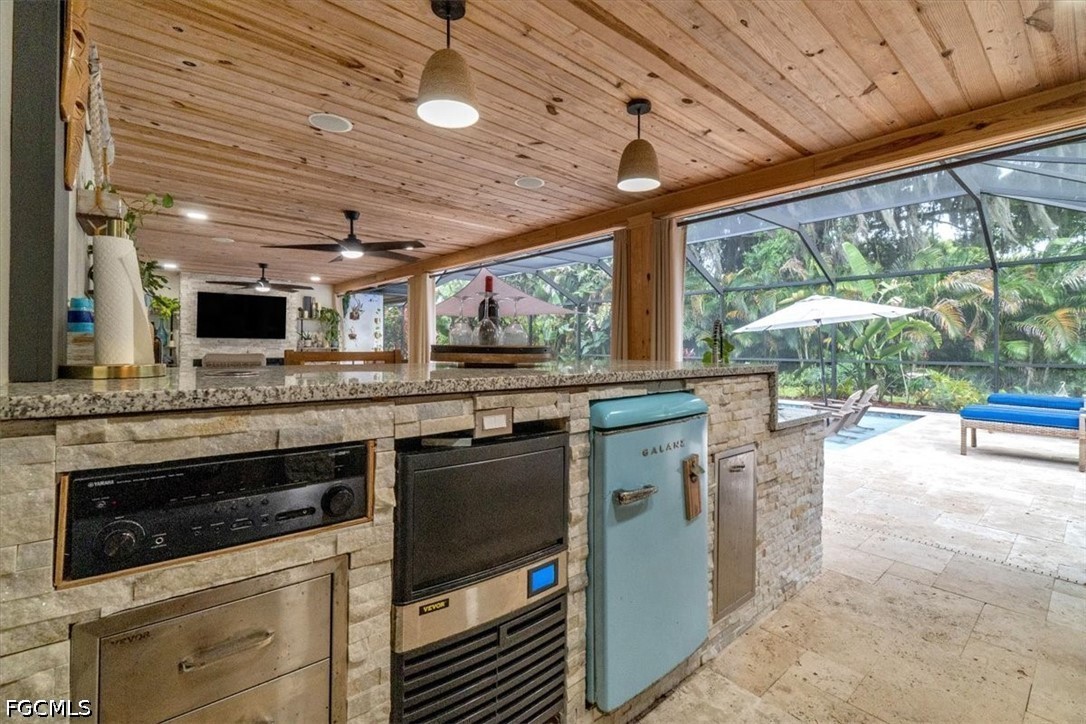 202 Ridgewood Avenue Clewiston, FL 33440 - Photo 29 of 50 a kitchen with stainless steel appliances granite countertop a stove and a microwave oven with large window