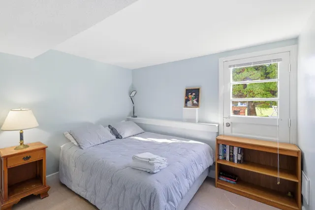 a bathroom with a sink mirror and a bathtub next to a window