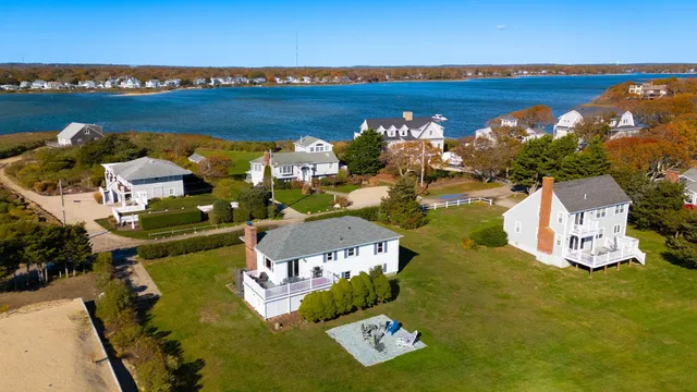 an aerial view of a house with a lake view