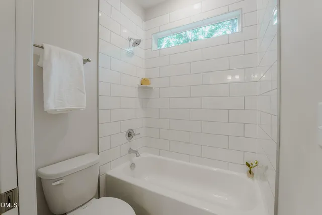 a bathroom with a toilet and bathtub