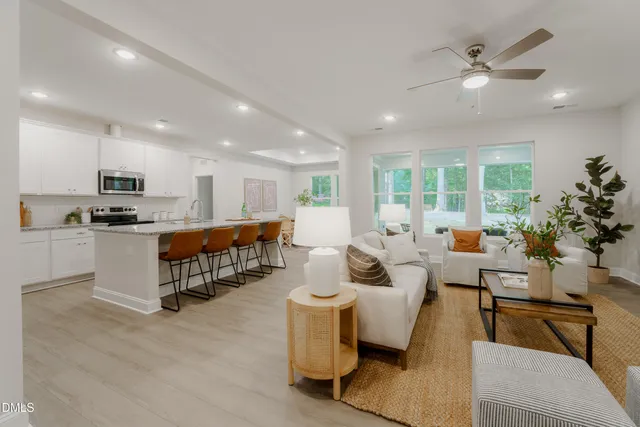 a living room with furniture and kitchen view