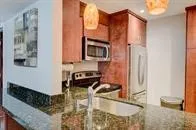 a kitchen with granite countertop a sink and a stove top oven