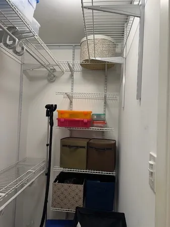 a utility room with closet and windows