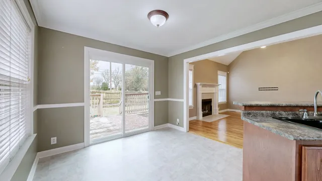 a view of open kitchen with kitchen island and stainless steel appliances
