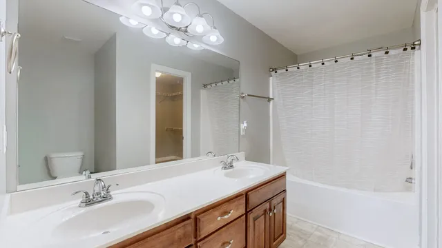 a bathroom with a sink double vanity and a mirror