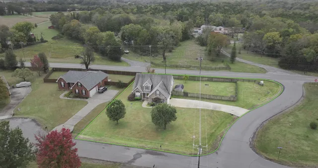 an aerial view of a house with outdoor space