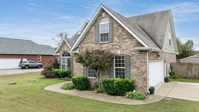 a view of a house with a yard and sitting area