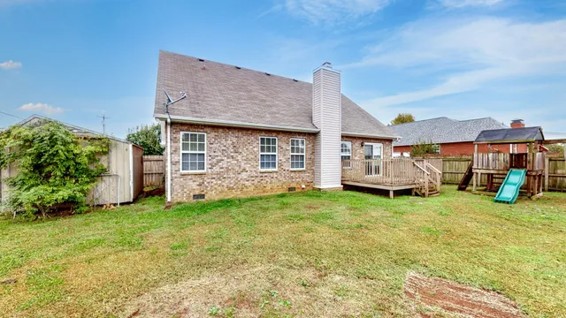 a view of a house with a backyard porch and sitting area