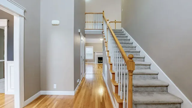 a view of a hallway with wooden floor and entryway
