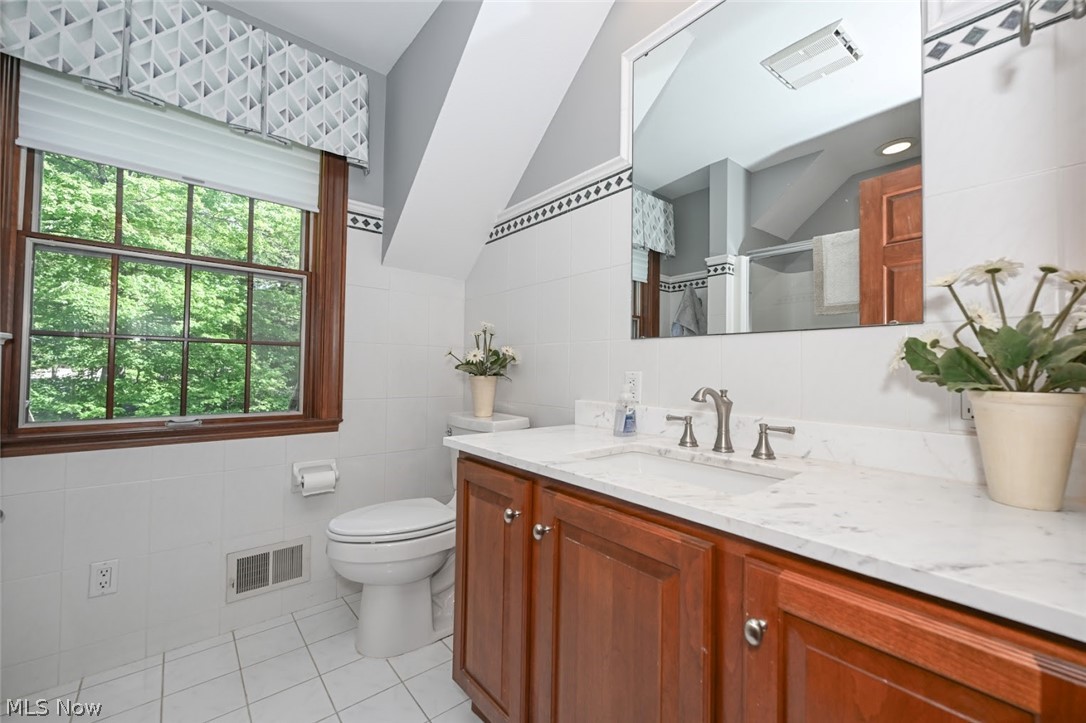 3530 Brush Road Richfield, OH 44286 - Photo 15 of 35 Bathroom featuring tile walls, tile flooring, plenty of natural light, and toilet