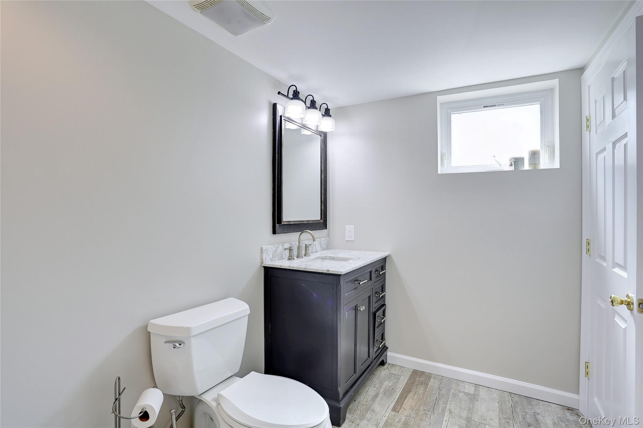 254 North Main Street New City, NY 10956 - Photo 30 of 37 a bathroom with a toilet a sink and mirror