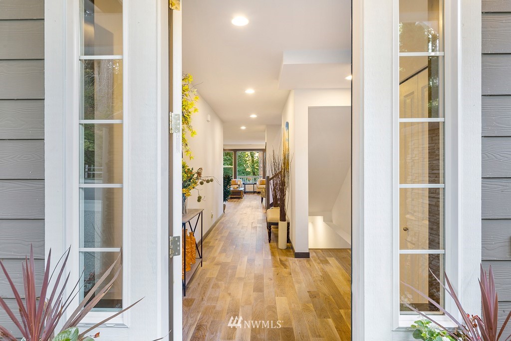 17507 3rd Avenue Southeast Bothell, WA 98012 - Photo 2 of 40 a view of a hallway with wooden floor windows and a livingroom