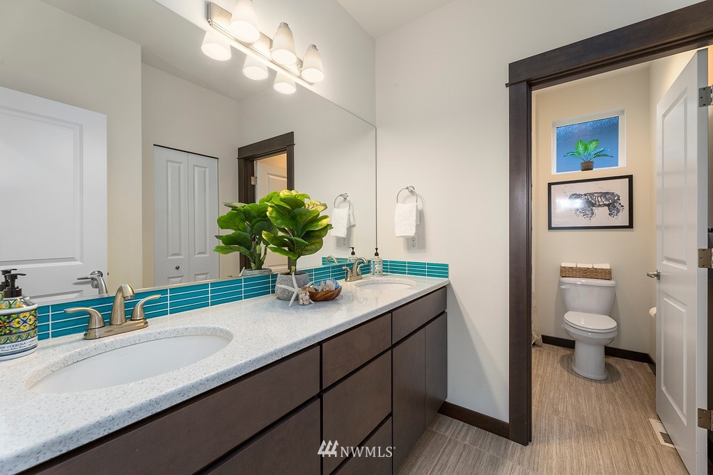 17507 3rd Avenue Southeast Bothell, WA 98012 - Photo 18 of 40 a bathroom with a sink a large mirror and a toilet