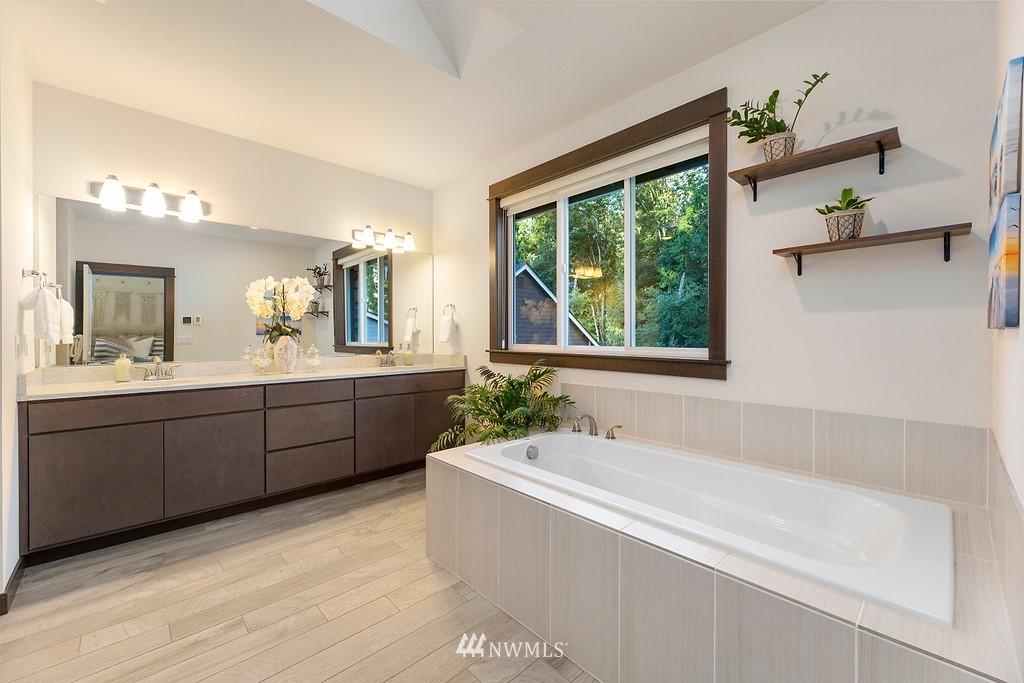 17507 3rd Avenue Southeast Bothell, WA 98012 - Photo 21 of 40 a spacious bathroom with a double vanity sink a large mirror and a bathtub