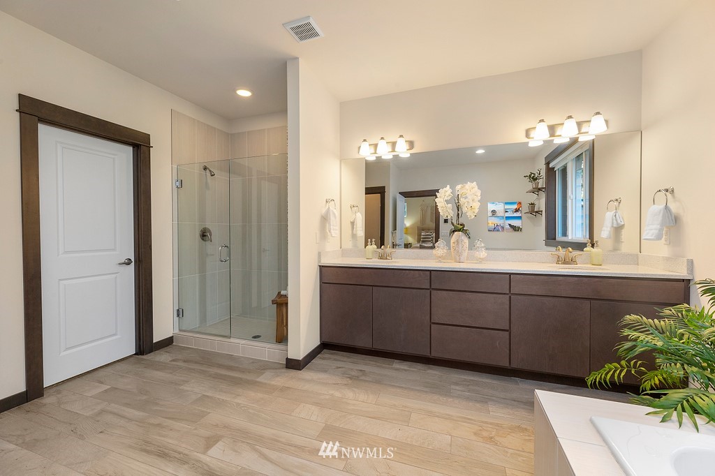 17507 3rd Avenue Southeast Bothell, WA 98012 - Photo 22 of 40 a spacious bathroom with a granite countertop sink a mirror and a shower