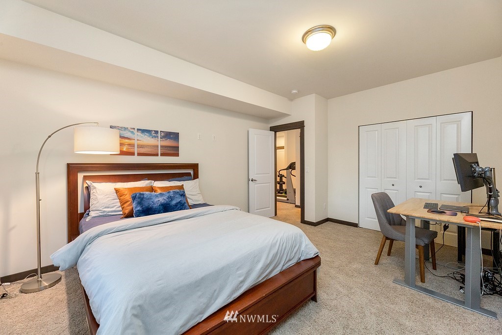 17507 3rd Avenue Southeast Bothell, WA 98012 - Photo 24 of 40 a bedroom with a bed and a table in it
