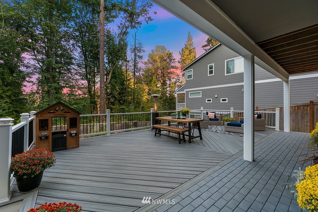17507 3rd Avenue Southeast Bothell, WA 98012 - Photo 29 of 40 a view of a roof deck with table and chairs with wooden floor and fence