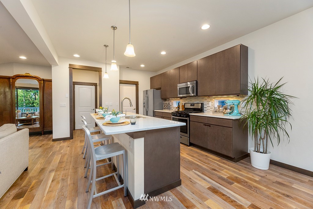 17507 3rd Avenue Southeast Bothell, WA 98012 - Photo 9 of 40 a kitchen with kitchen island a counter top space a sink stainless steel appliances and cabinets