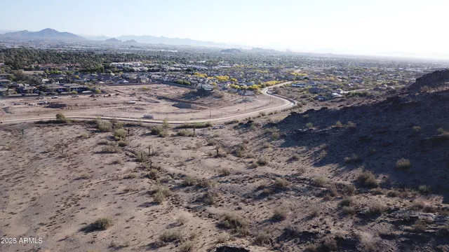 an aerial view of a house with a mountain