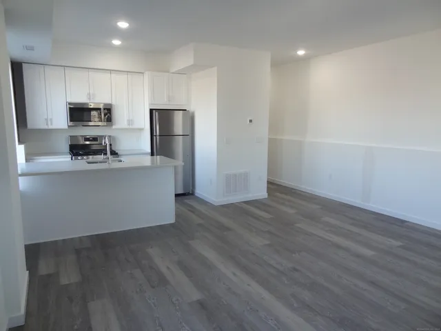a kitchen with stainless steel appliances a refrigerator and a stove top oven