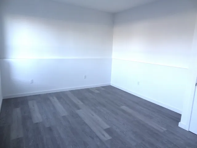 an empty room with wooden floor