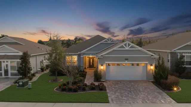 a kitchen with stainless steel appliances kitchen island granite countertop a table chairs sink and cabinets