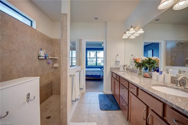 a bathroom with a double vanity sink and a mirror