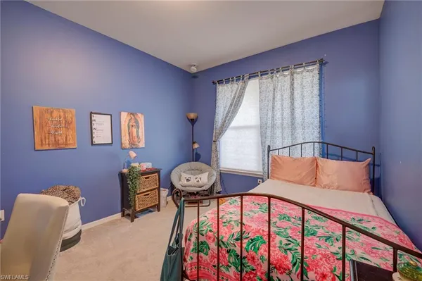 a bedroom with furniture and a window