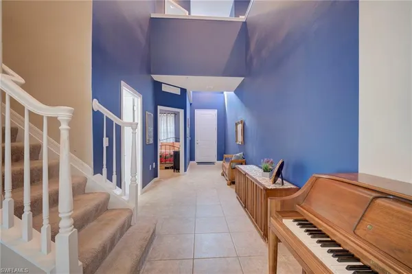 a hallway with furniture and stairs