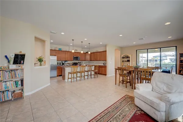 a living room with furniture and a dining table with kitchen view