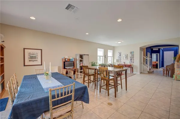 a living room with furniture a dining table and a piano table