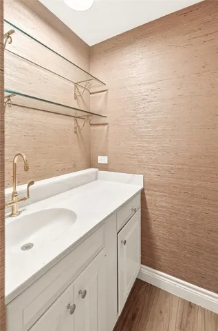 a spacious bathroom with a tub sink and mirror