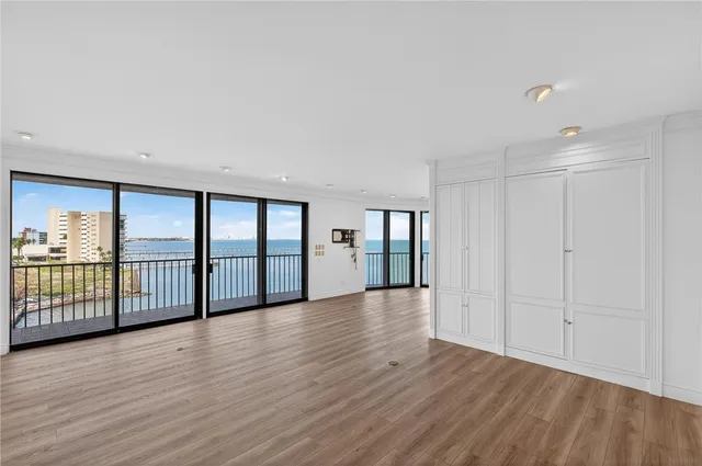 a kitchen with white cabinets and sink