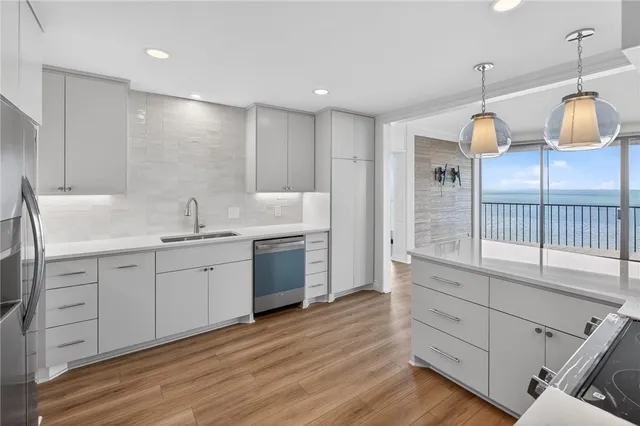 a kitchen with granite countertop a stove and a wooden floors
