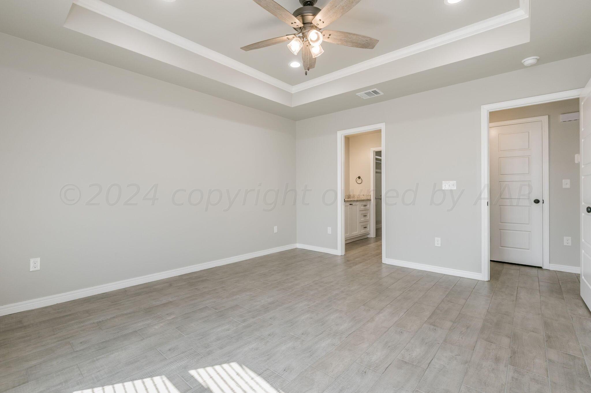 13987 Periwinkle Drive, Unit 1 Amarillo, TX 79119 - Photo 12 of 20 an empty room with fan and entrance