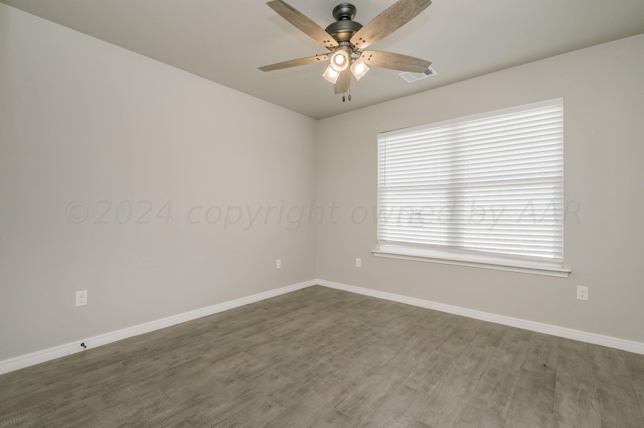 13987 Periwinkle Drive, Unit 1 Amarillo, TX 79119 - Photo 16 of 20 a view of an empty room with a window
