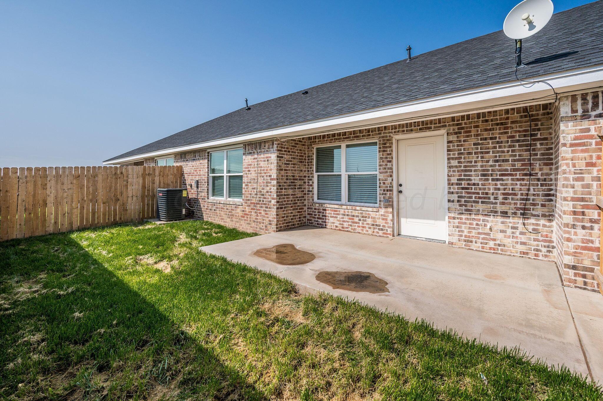 13987 Periwinkle Drive, Unit 1 Amarillo, TX 79119 - Photo 19 of 20 a front view of house with yard and outdoor seating