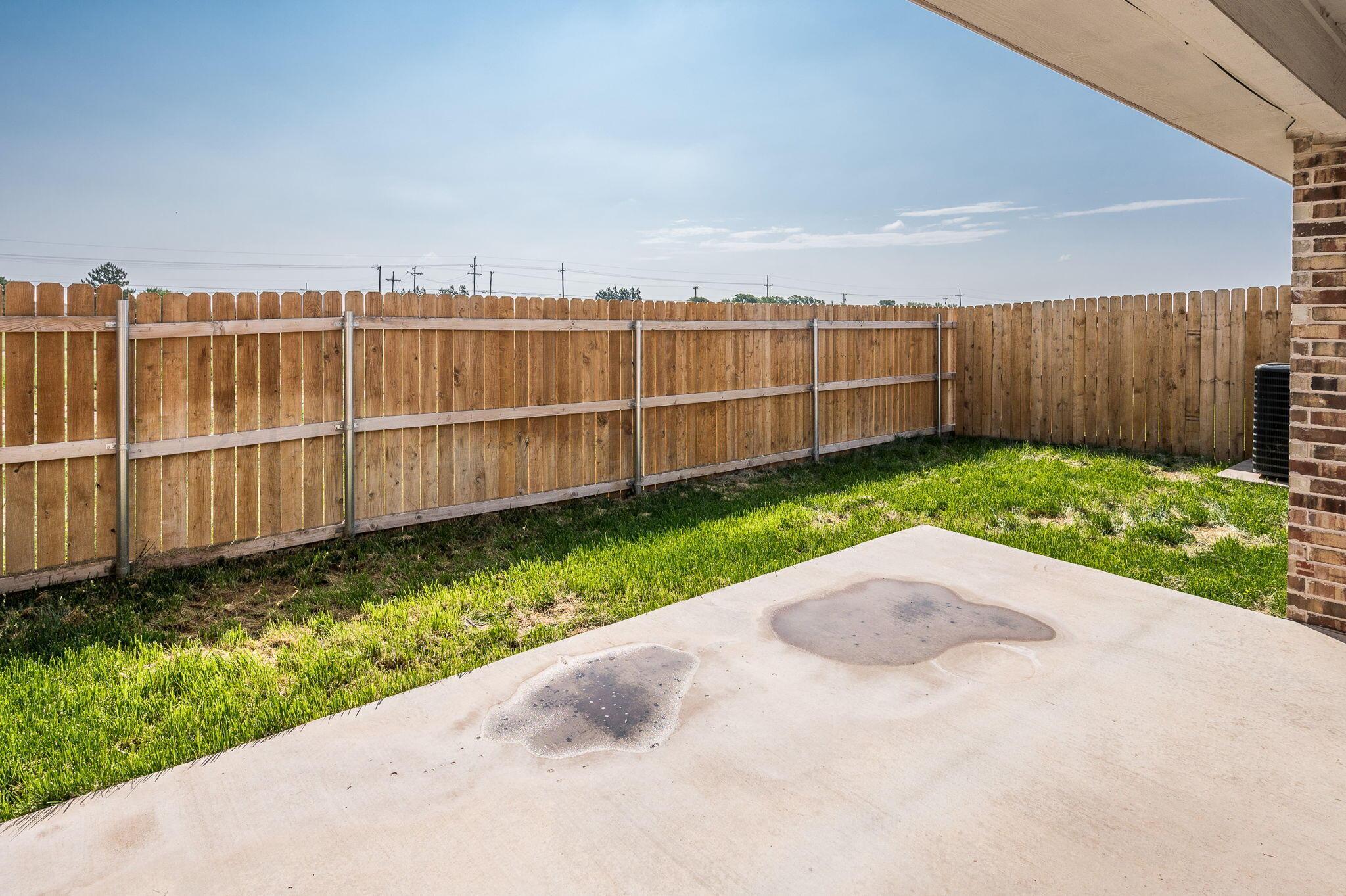 13987 Periwinkle Drive, Unit 1 Amarillo, TX 79119 - Photo 20 of 20 a view of a backyard with wooden fence