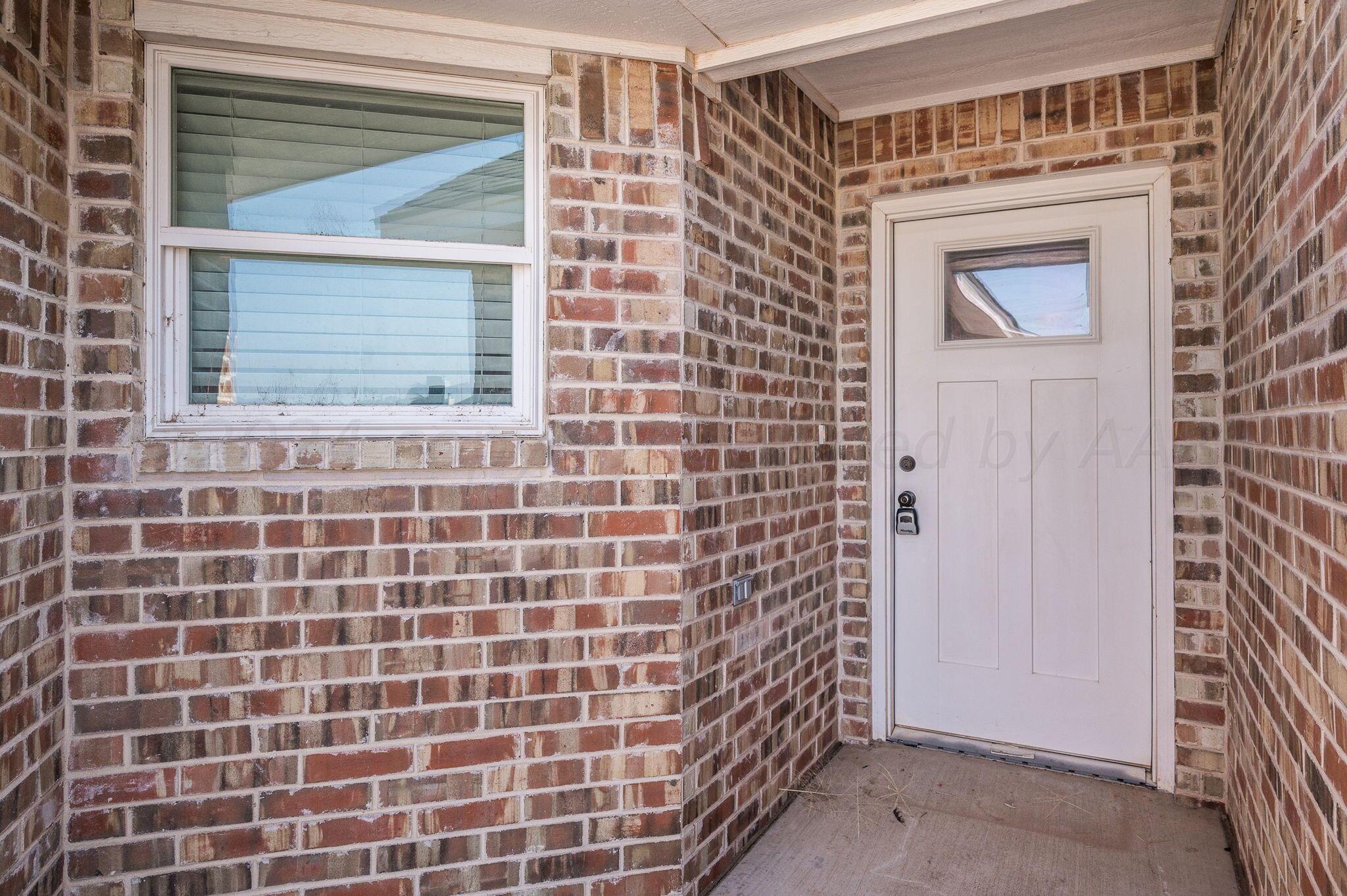 13987 Periwinkle Drive, Unit 1 Amarillo, TX 79119 - Photo 3 of 20 a view of a brick house