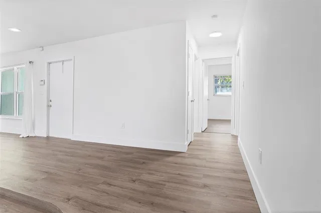 a view of a hallway with wooden floor
