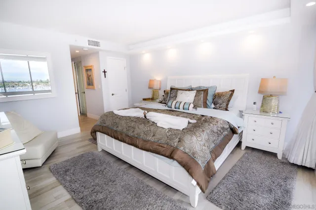 a spacious bedroom with a bed and window