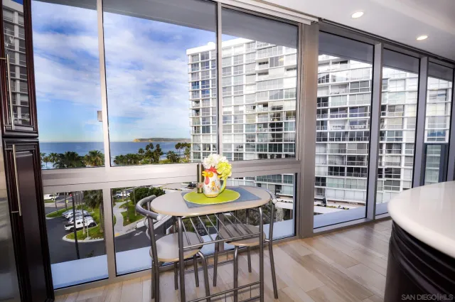 a view of a dining room with furniture a chandelier and wooden floor