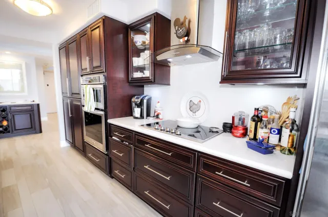 a kitchen with stainless steel appliances granite countertop a sink dishwasher and cabinets with wooden floor