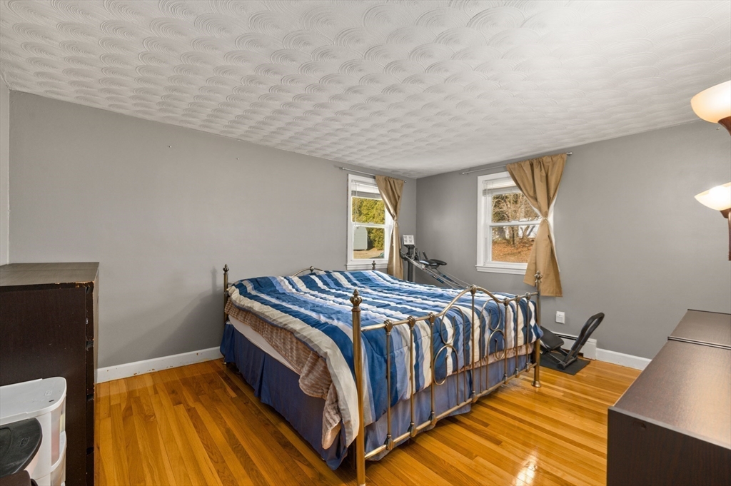 3 Athens Drive Saugus, MA 01906 - Photo 11 of 33 a bedroom with a bed and wooden floor