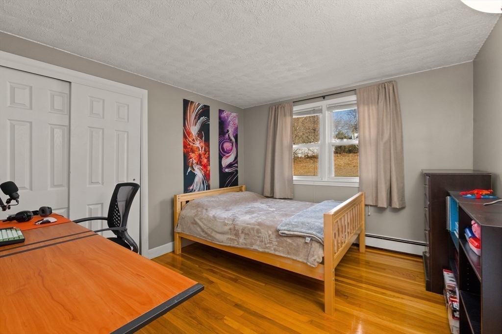 3 Athens Drive Saugus, MA 01906 - Photo 15 of 33 a bedroom with a bed table and a window